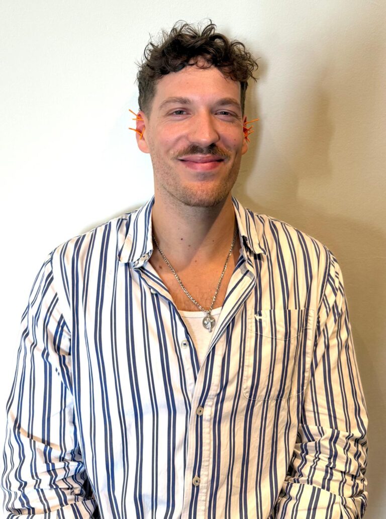 A participant in a striped shirt smiling at the camera