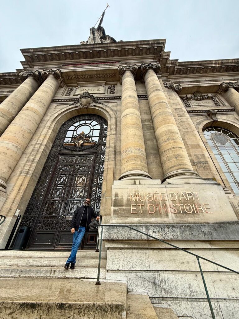 A visitor standing on the steps of the Musée d’Art et d’Histoire in Geneva