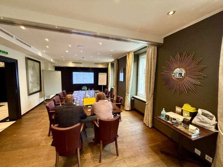 The meeting room set up with chairs and a screen